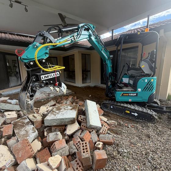 Brick and concrete rubble pulled out beside a house