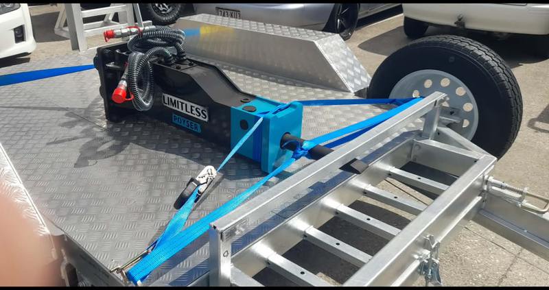Hydraulic breaker strapped down for transport