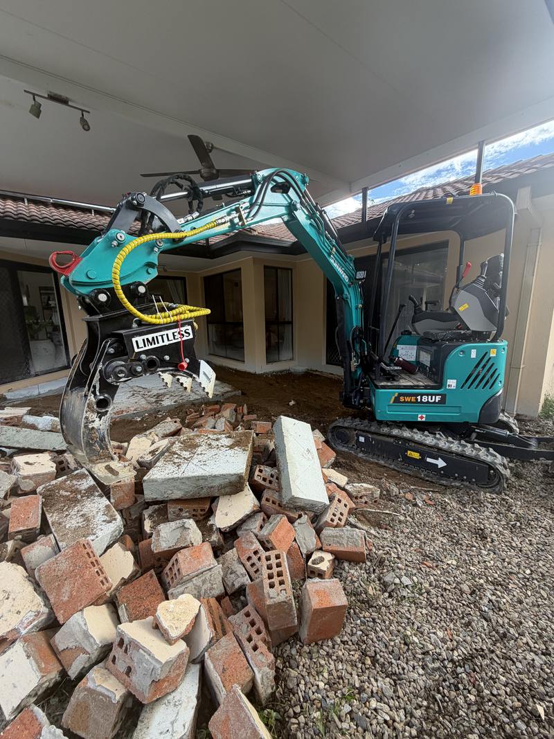Brick and concrete rubble pulled out beside a house