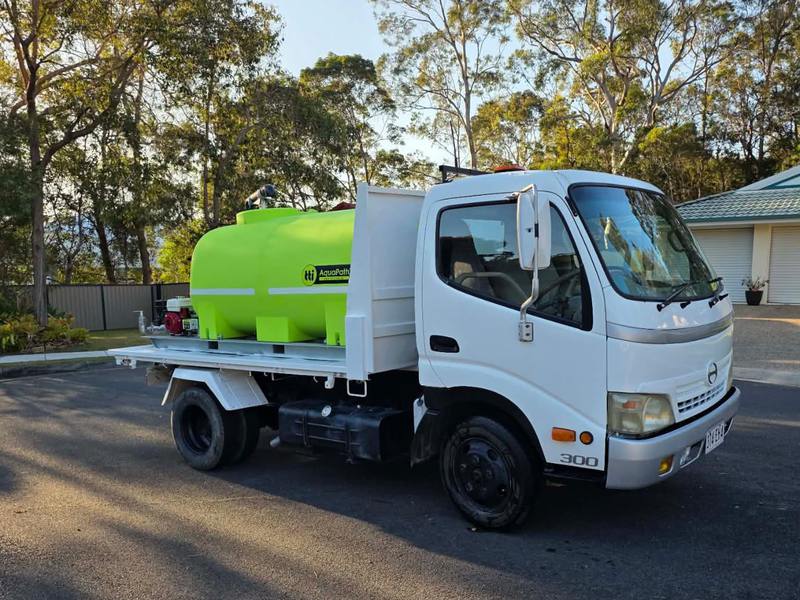 The water cart with its 2,000-litre AquaPath tank, pump and hose reel on the tray