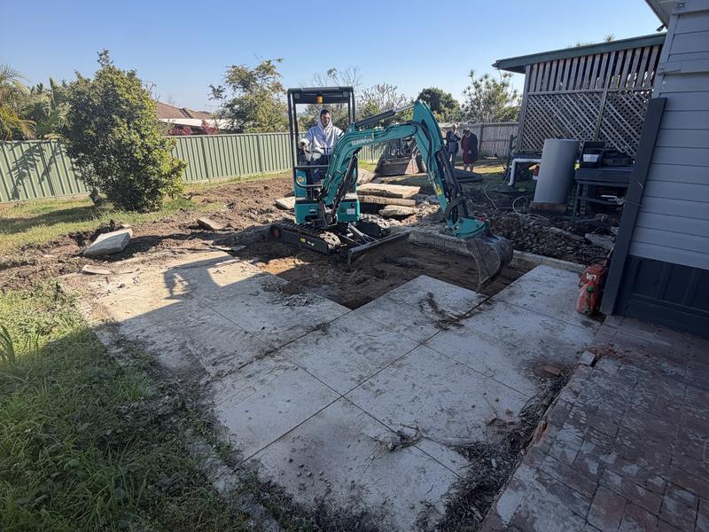 The 1.8T alongside a cut concrete path in a back yard